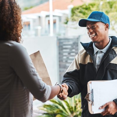 shot-of-a-courier-shaking-hands-with-a-customer-wh-2023-11-27-05-24-18-utc-min